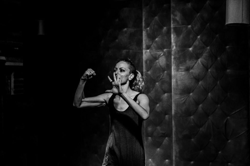 Black and white image of Gillian pounding against an invisible wall