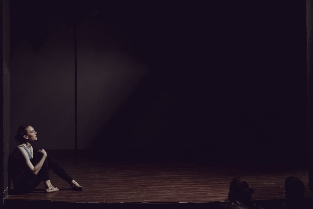 a large empty space with gillian sitting at one side looking up