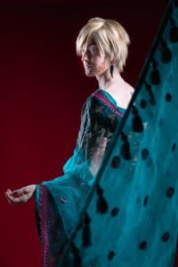 gillian as a man in a sari facing away from the camera and looking back over his shoulder