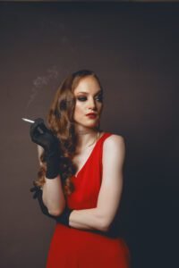 Gillian as the lady in red looking contemptuously to the side