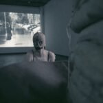 Gillian as monster peeking from behind a structure with a projection behind her