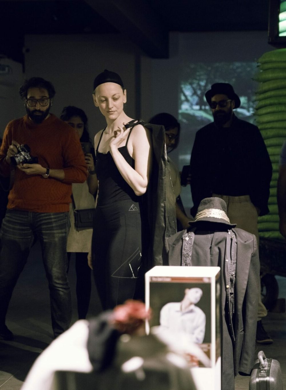 Gillian in a gallery space in a wig cap